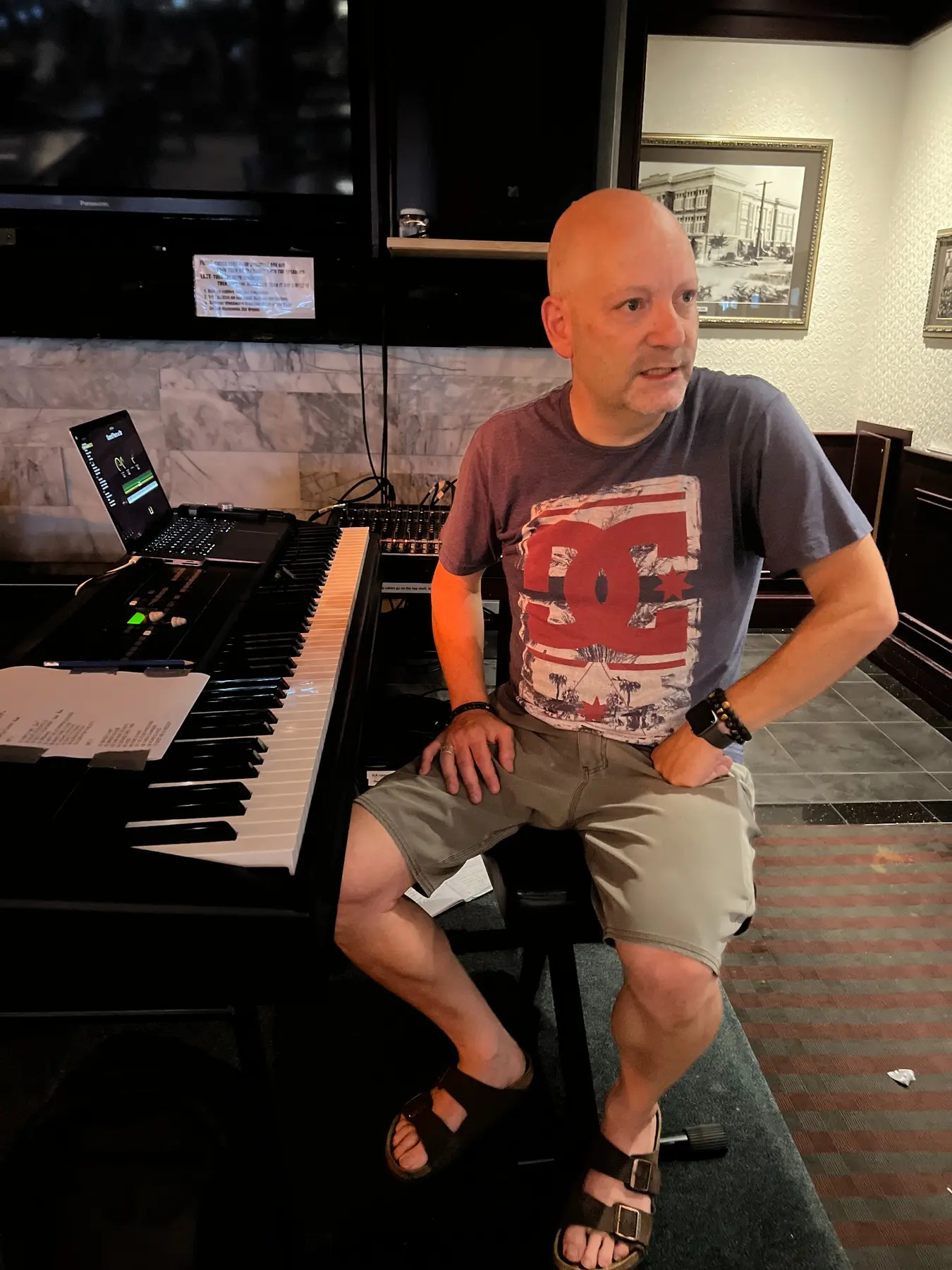Paul beside his professional keyboard and live music setup
